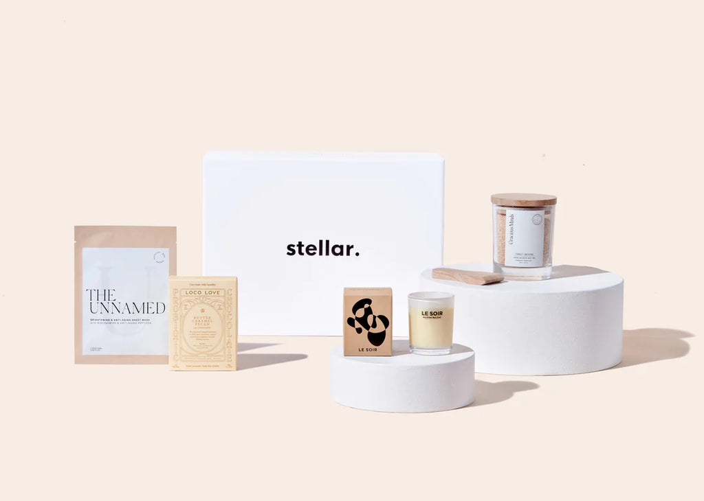 Stellar's The Soak Gift Set, including a sheet mask, candle, and artisan soap in a minimalistic display.